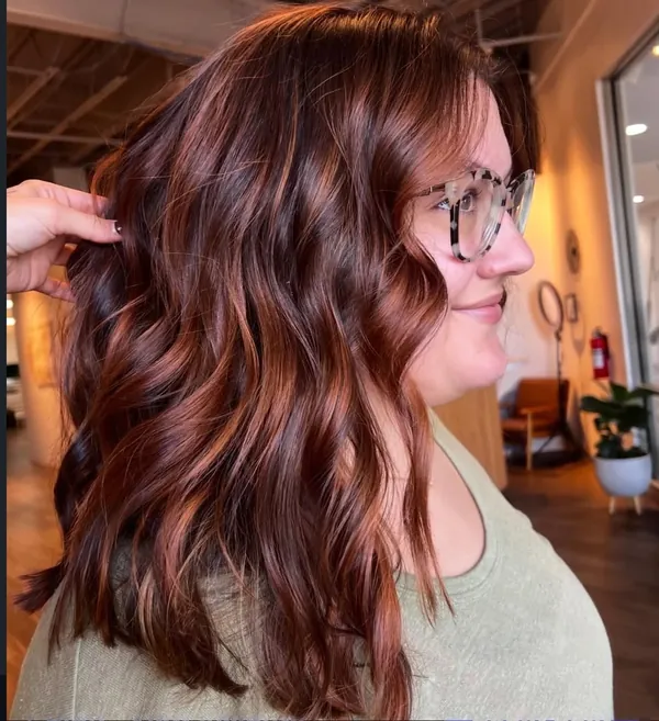 Deep auburn hair with copper ribbons through soft waves