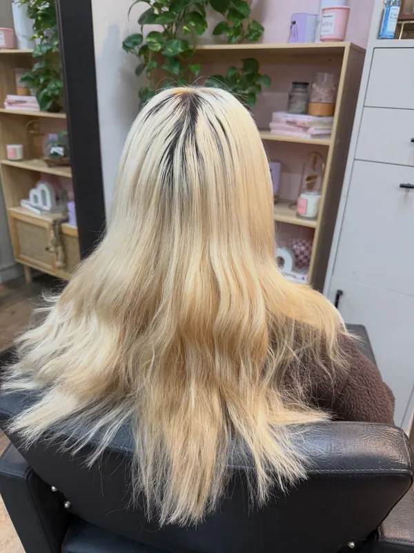 Before: blonde hair with dark grown-out roots and uneven, yellow-toned ends