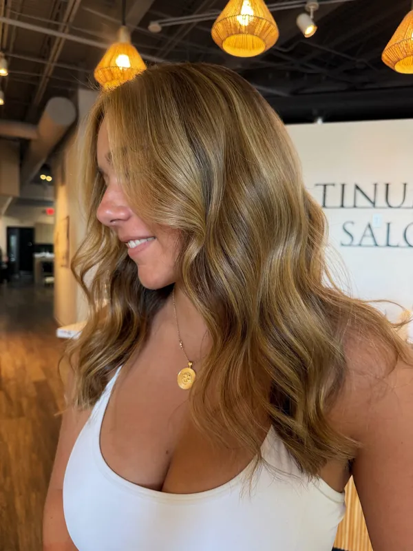 Warm honey and caramel balayage in loose waves