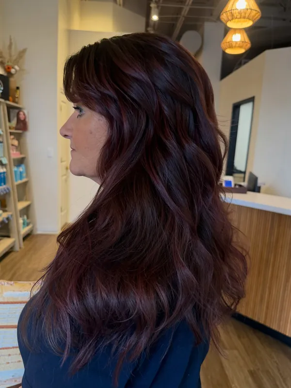 After: long, deep violet-burgundy hair in soft waves